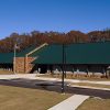 Single-story building with green roof and parking lot