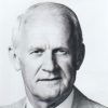 Older white man in striped suit and tie