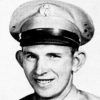 Young white man smiling in military uniform with cap