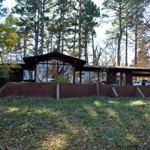 Single-story house with retaining wall prominent front-facing windows