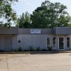 Single-story building with covered entrances on parking lot