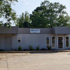 Single-story building with covered entrances on parking lot