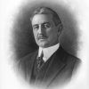 White man with mustache in three-piece suit above signature reading "R. E. Lee Wilson"