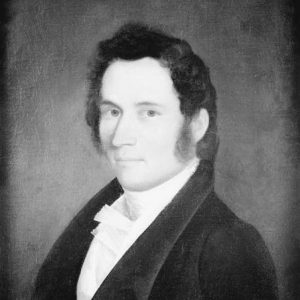 White man with dark hair in suit and tie