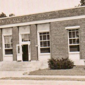 Brick post office building with steps leading up to open doors