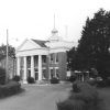 Two-story brick building with four columns and dome roof