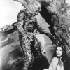 Man in monster suit reaching for white woman in a bathing suit