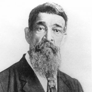 Old African-American man with a long beard in suit wearing a medal