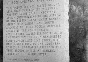 Stone monument "Ouachita County Poison Springs Battlefield" with trees in the background