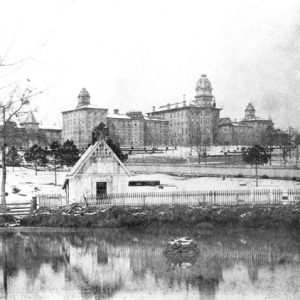 Sprawling multistory complex with pond in the foreground