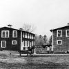 Pair of two-story wood frame buildings with bridge between