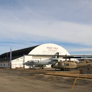 airplane hangar labeled "Drake Field Fayetteville" with military airplane and helicopter