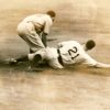 White man in uniform number 21 sliding onto base