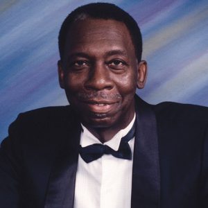 African-American man smiling in suit and bow tie