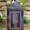 Black stone monument with bust on top and plaque on its front