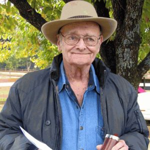 older white man holding knife and sheath