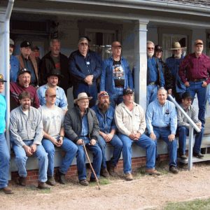 group of white men posed on wooden porch