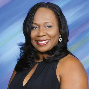 African-American woman smiling in sleeveless black dress