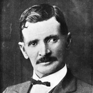 African-American man with mustache in suit and tie