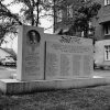 stone monument one side dedicated to Edgar Harold Buck Lloyd the other "Dedicated by the citizens of Mississippi County in grateful tribute to these men and women who gave their lives in defense of our country in World Wars One and Two" with four columns of names underneath