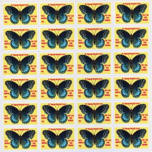 Book of stamps with blue butterfly and red text on yellow backgrounds