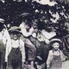 White children posing with donkey