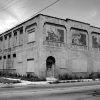 two story brick building with three images of clowns "Bartleby Clown College"