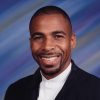 African-American man with mustache and beard in suit