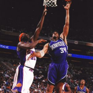 several African American men playing basketball in stadium