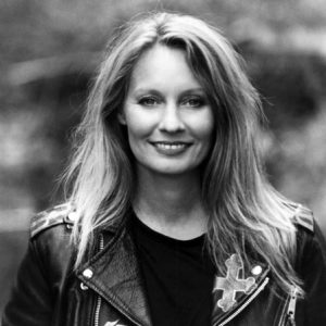 white woman in black shirt and leather jacket