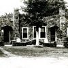 Stone house-like building with car in garage