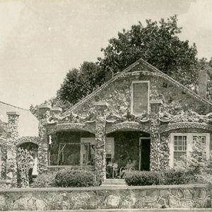 Brick and stone house with rock wall