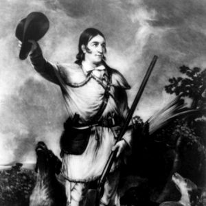 illustration of white man in animal skin clothes holding a rifle and waving a hat with a dog on either side of him