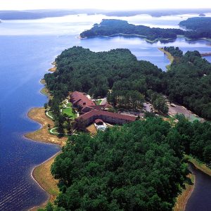 elevated view of sprawling resort complex in wooded area by the lakeside