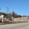 Single-story stone storefront building on rural road