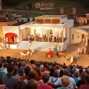 Mixed crowd watching outdoor stage play