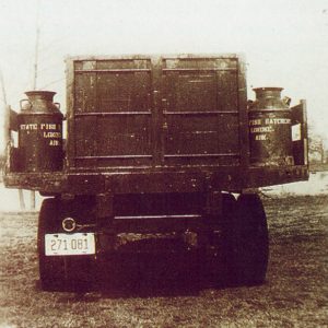 rear view of truck on the sides of which are containers reading "State Fish Hatchery Lonoke Ark."