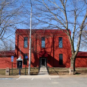 red two story building with payphone in front