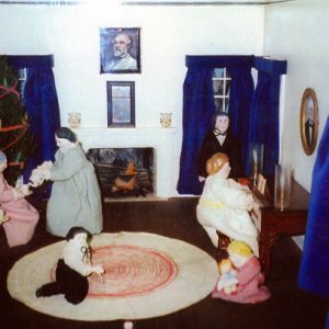 Model house with white family dolls, Christmas tree, fireplace, piano, paintings, window curtains