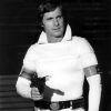 Portrait white male actor in space costume with ray gun utility belt arm bands