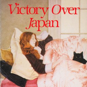 Book cover white woman with red hair and black cat in bed with by pink comforter "Victory over Japan Short Stories by Ellen Gilchrist"