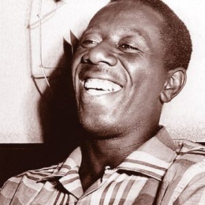 African-American man laughing in plaid shirt