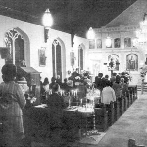 Crowd of people praying in church