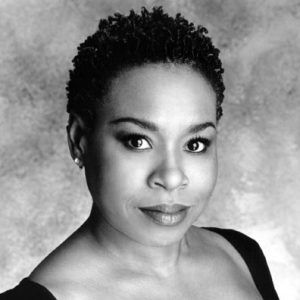 African-American woman with short hair in black dress