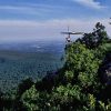 person in hang gliding gear on edge of cliff