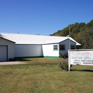 white building with green trim "Brumley Hartford Music Co. Music Publishers Powell, Missouri"