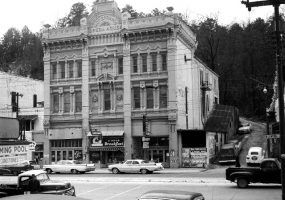 Detailed multistory building with carved curtain detail facade and street level "swimming pool" "breakfast" signs