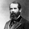 White man with long beard in suit and tie