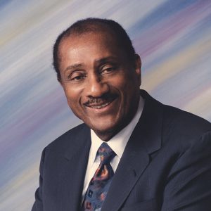 African-American man smiling in suit and tie