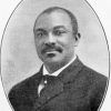 African-American man with mustache in suit and tie